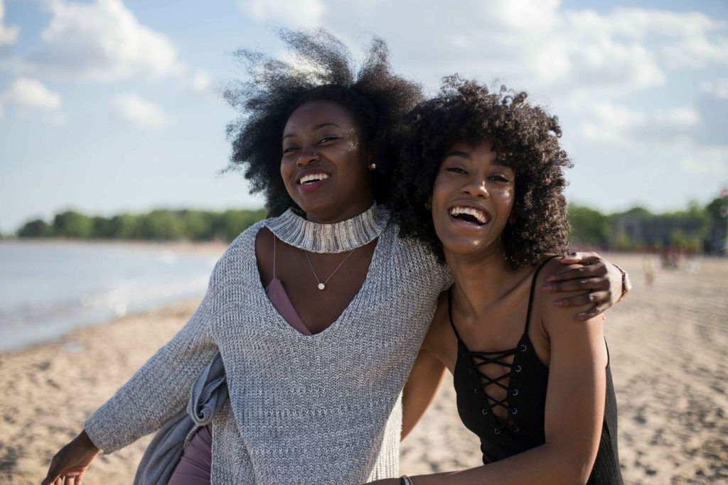 One friend quietly supporting another over tea during a mental health crisis